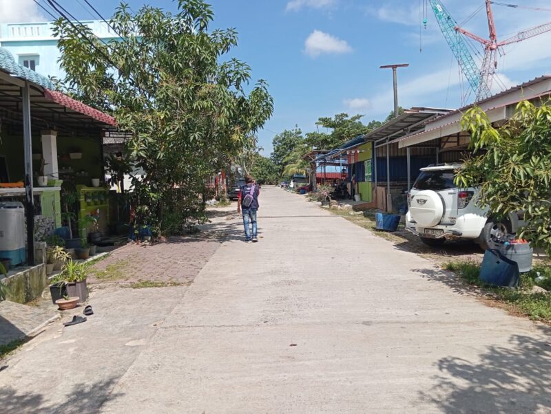 Seorang warga sedang melintas didepan bangunan di lahan kosong di perumahan Parisa indah, Kelurahan Sungai Langkai, Sagulung. Matapedia6.com/Luci