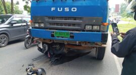 Motor Honda Beat hitam yang terlindas sangkut di roda depan truk molen di jalan Gajah Mada Sekupang Kota Batam, Jumat (25/4/2025). Matapedia6.com/Luci
