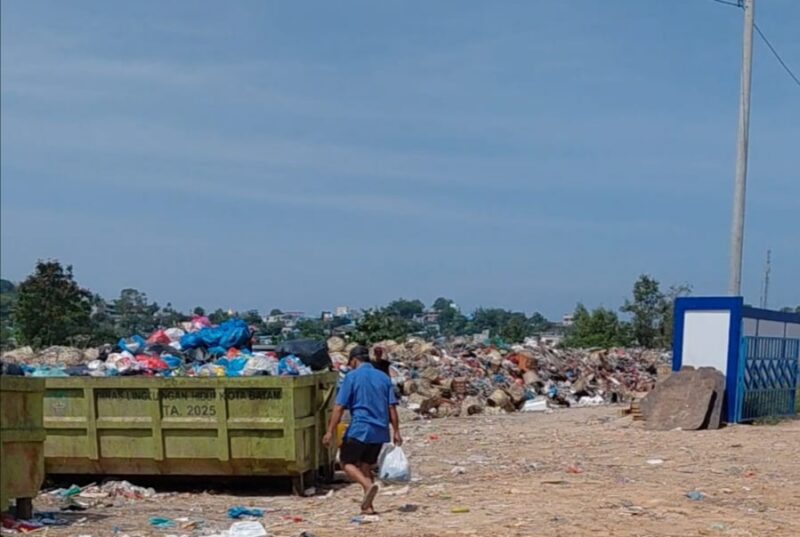 Seorang warga sedang membuang sampah ke Bin Kontainer yang ada di lokasi rumah pompa air, Jodoh, Nagoya kota Batam, Provinsi Kepri, Selasa (10/3/2026). Matapedia6.com/Luci