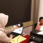 Petugas Imigrasi saat mengambil foto untuk proses pembuatan paspor di waktu hari libur. Foto:Istimewa
